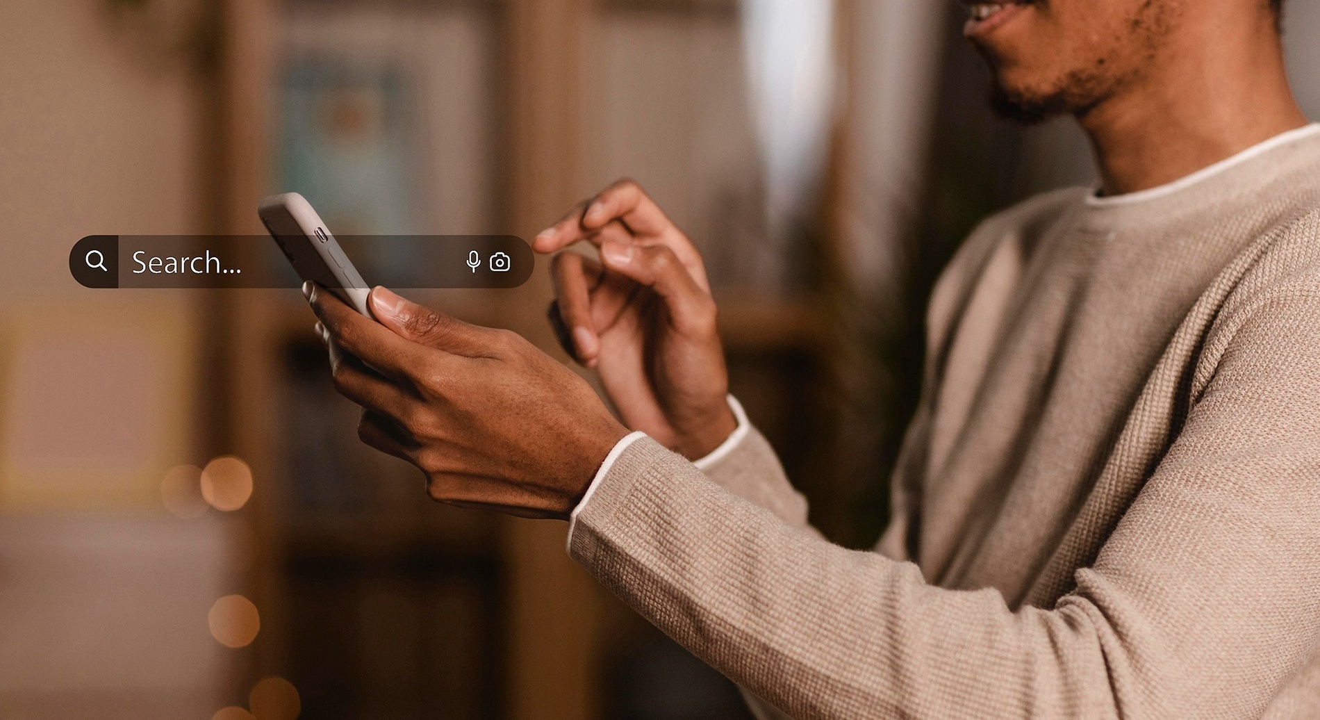 a man using a cell phone with a search bar on the screen