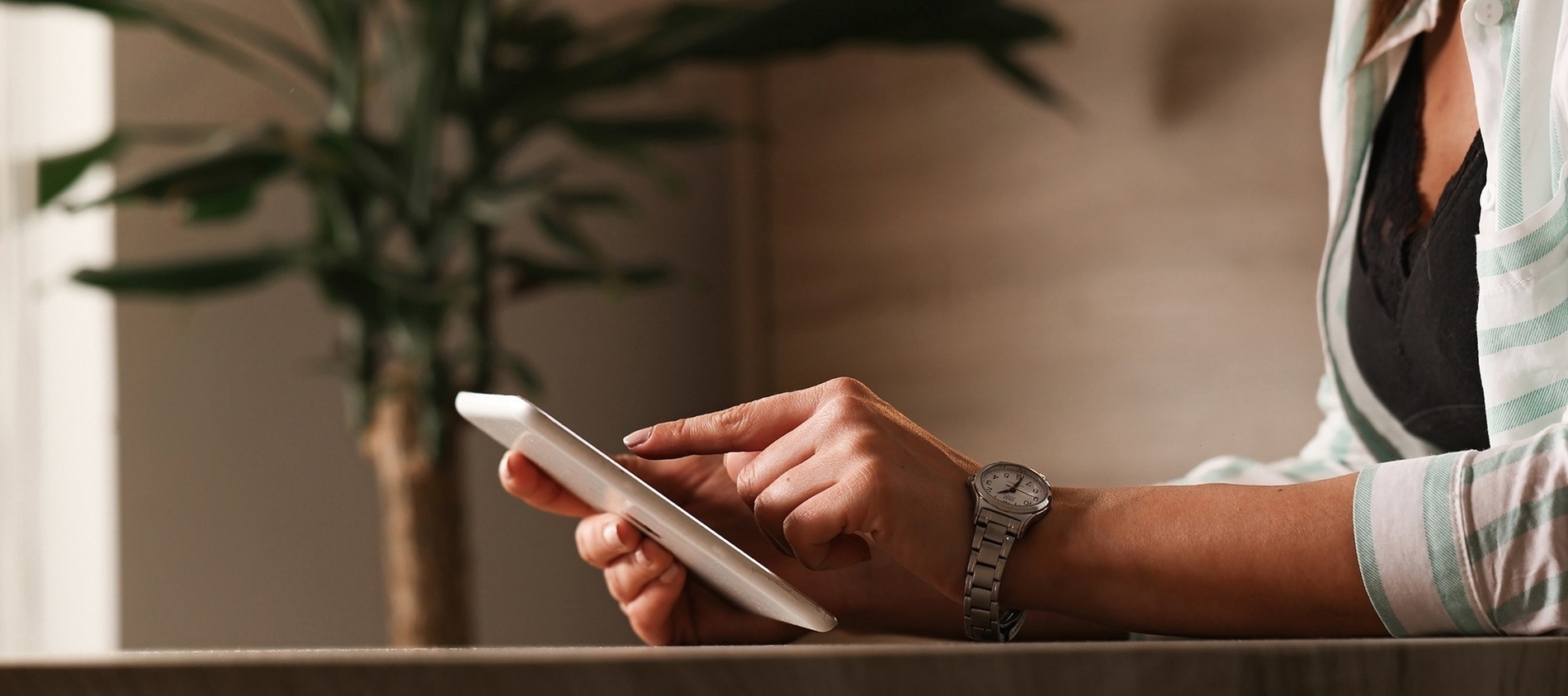 a woman wearing a watch is using a cell phone