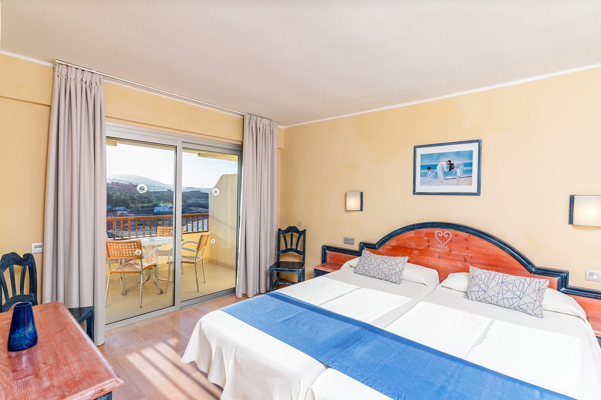 a hotel room with two beds and a balcony