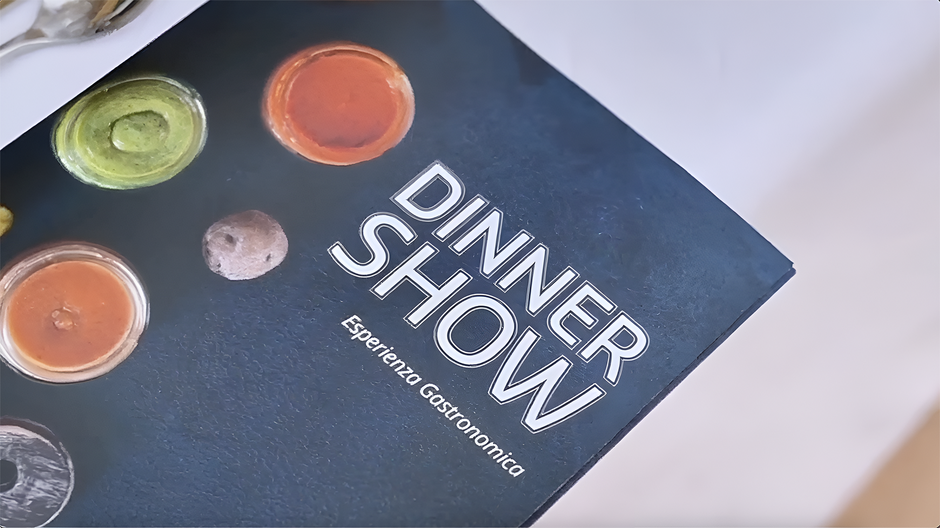 a book titled dinner show is on a table