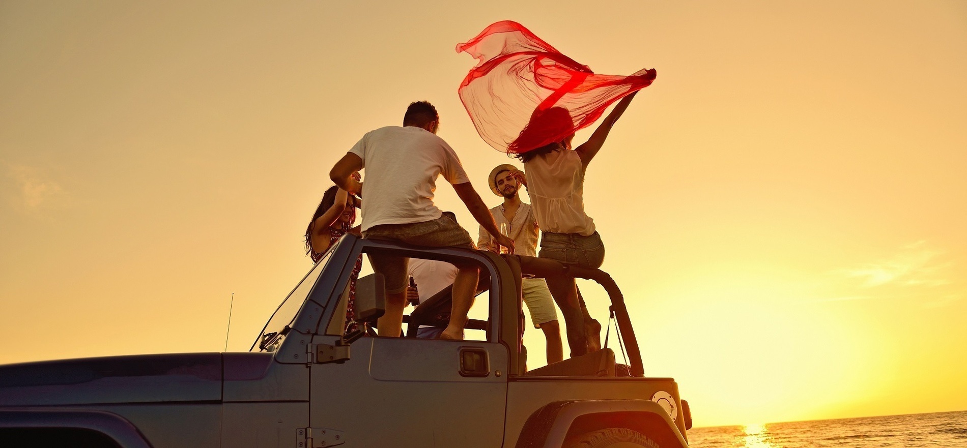 a family sits in the back of a car with an inflatable flamingo