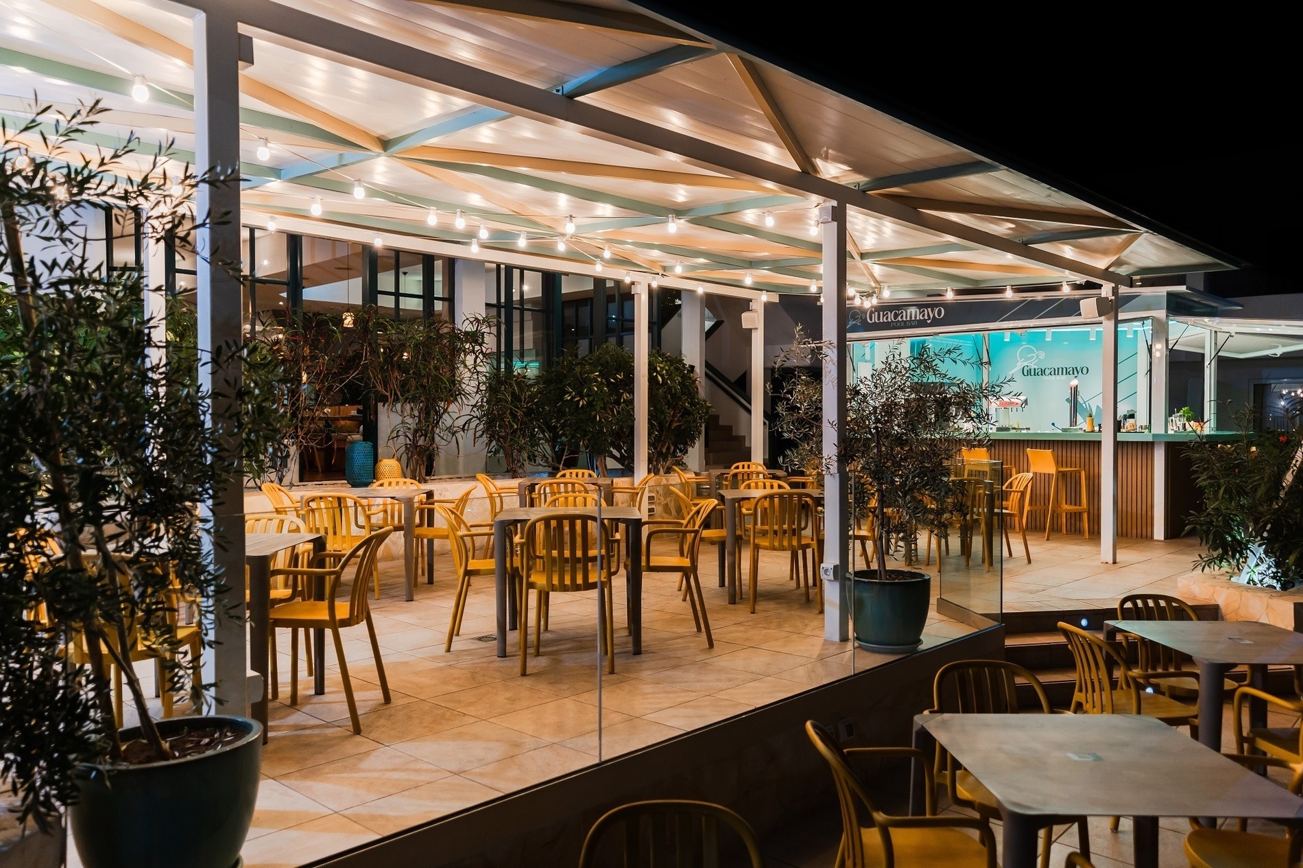 a large swimming pool surrounded by chairs and umbrellas