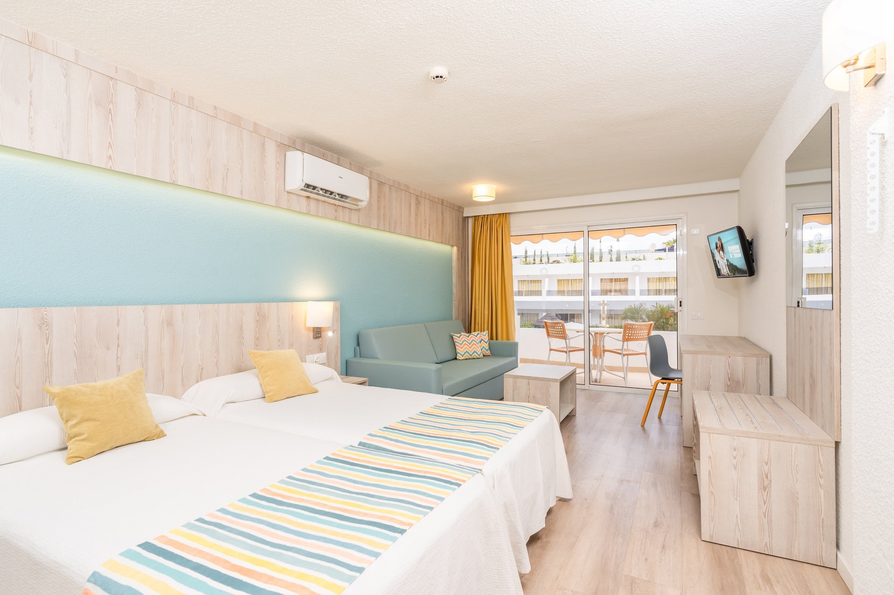 una habitación de hotel con dos camas y un sofá