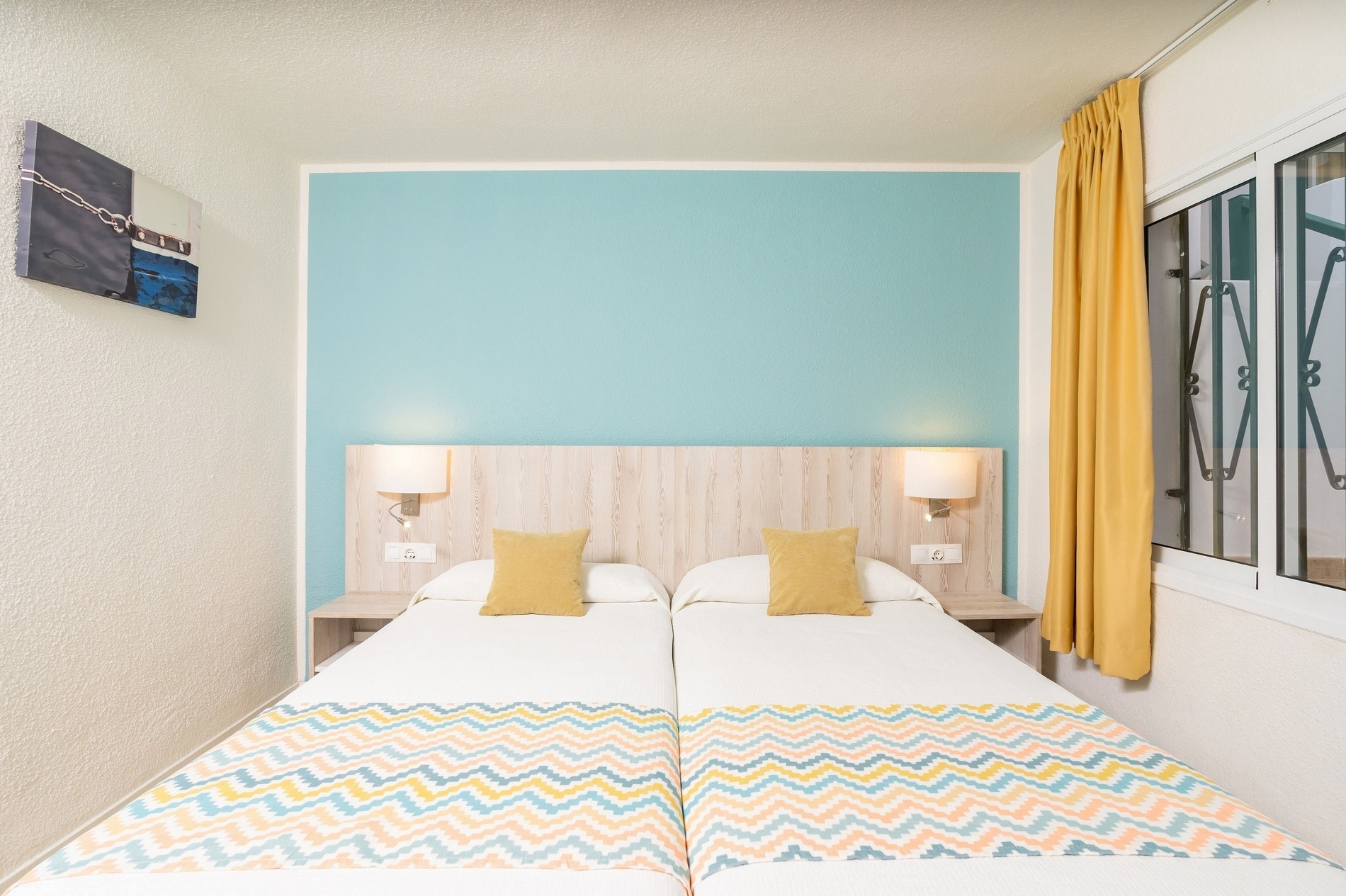 una camera da letto con due letti e cuscini colorati