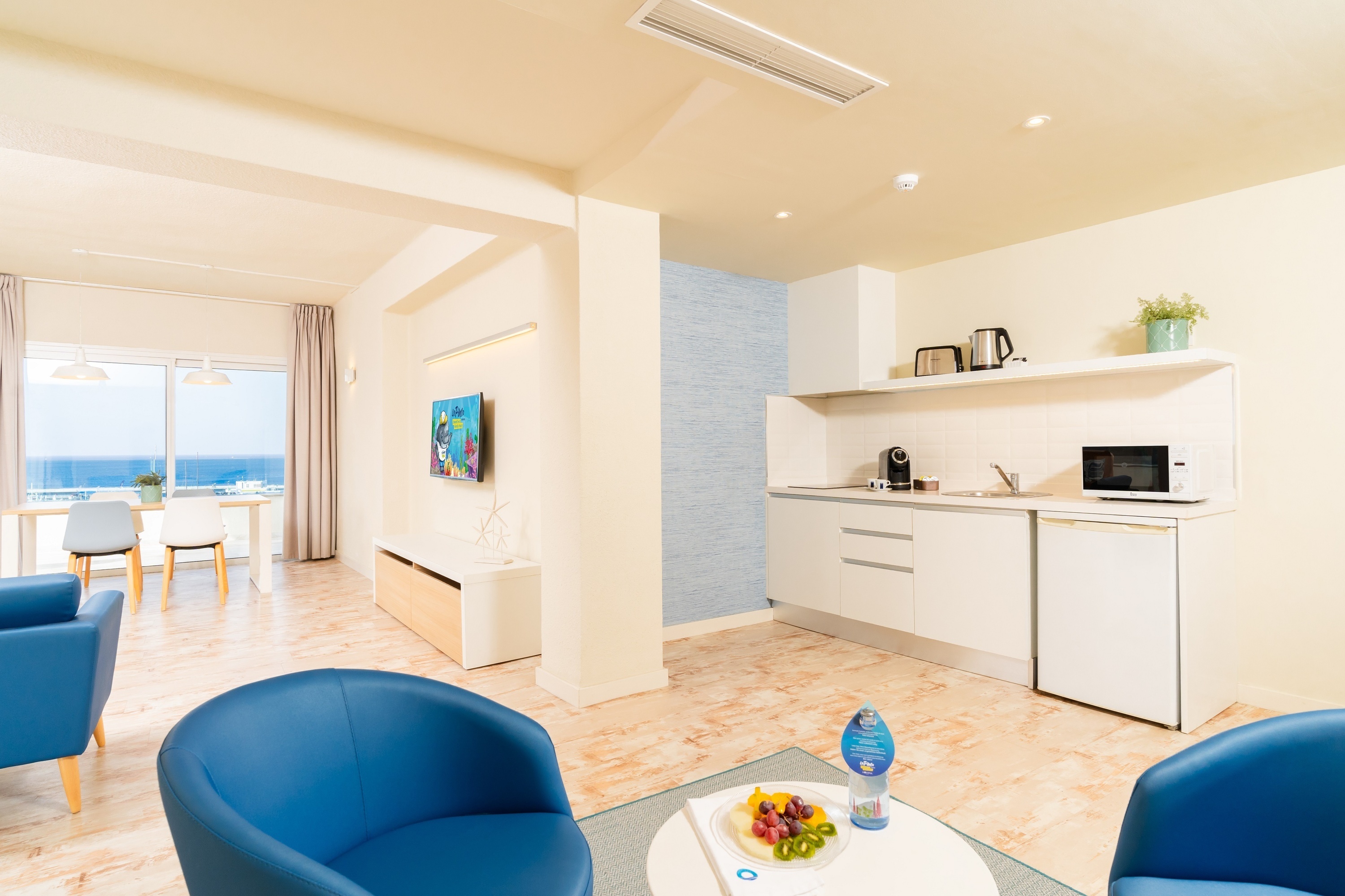 una mesa de comedor con sillas y una botella de vino