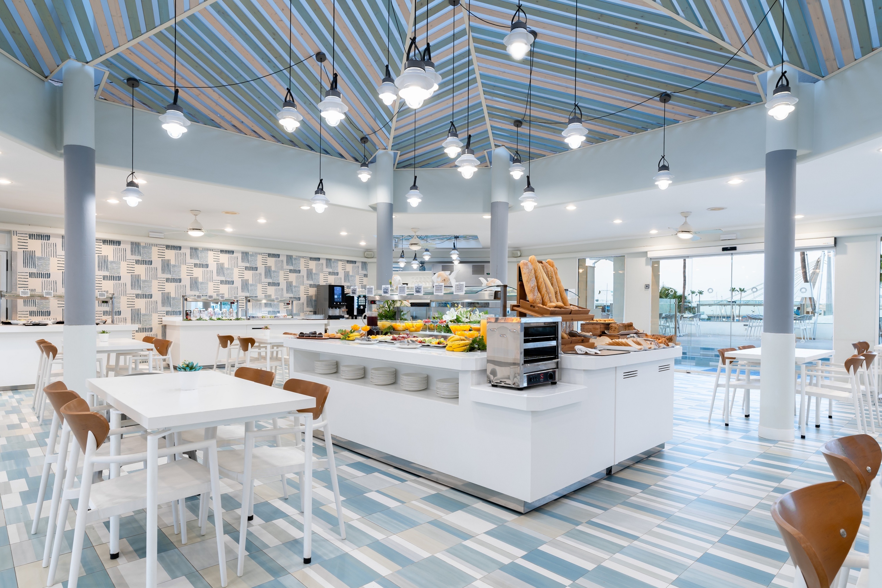 
                                    tables and chairs in a restaurant with a striped ceiling