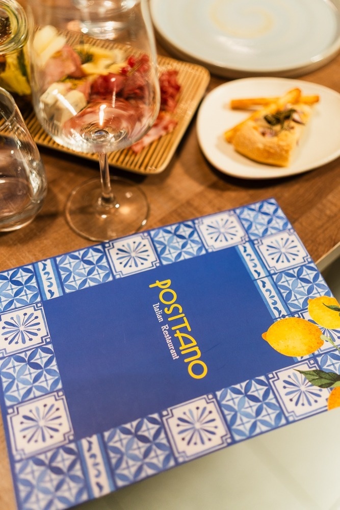 a green heart shaped leaf on a sandy beach