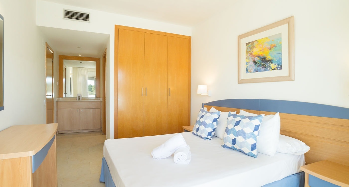 un dormitorio con una cama y una pintura en la pared