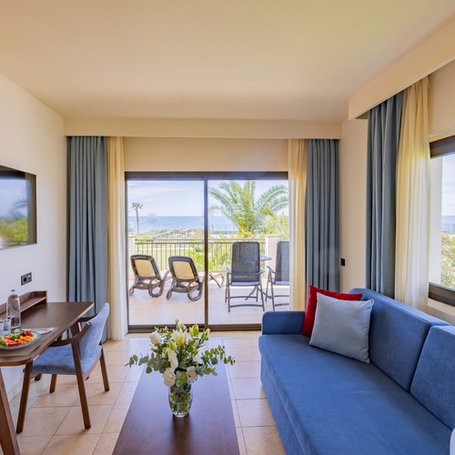 un balcón con una mesa y sillas y una botella de agua