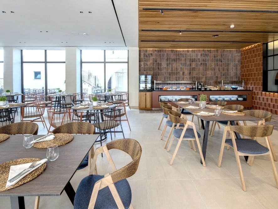 Modernes Hotelrestaurant mit gedeckten Tischen und Buffet. Impressive Playa Granada