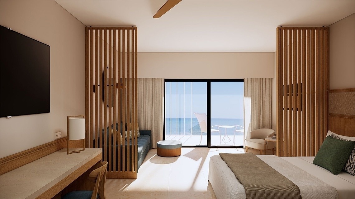 спальня с кроватью , столом и стулом с видом на океан