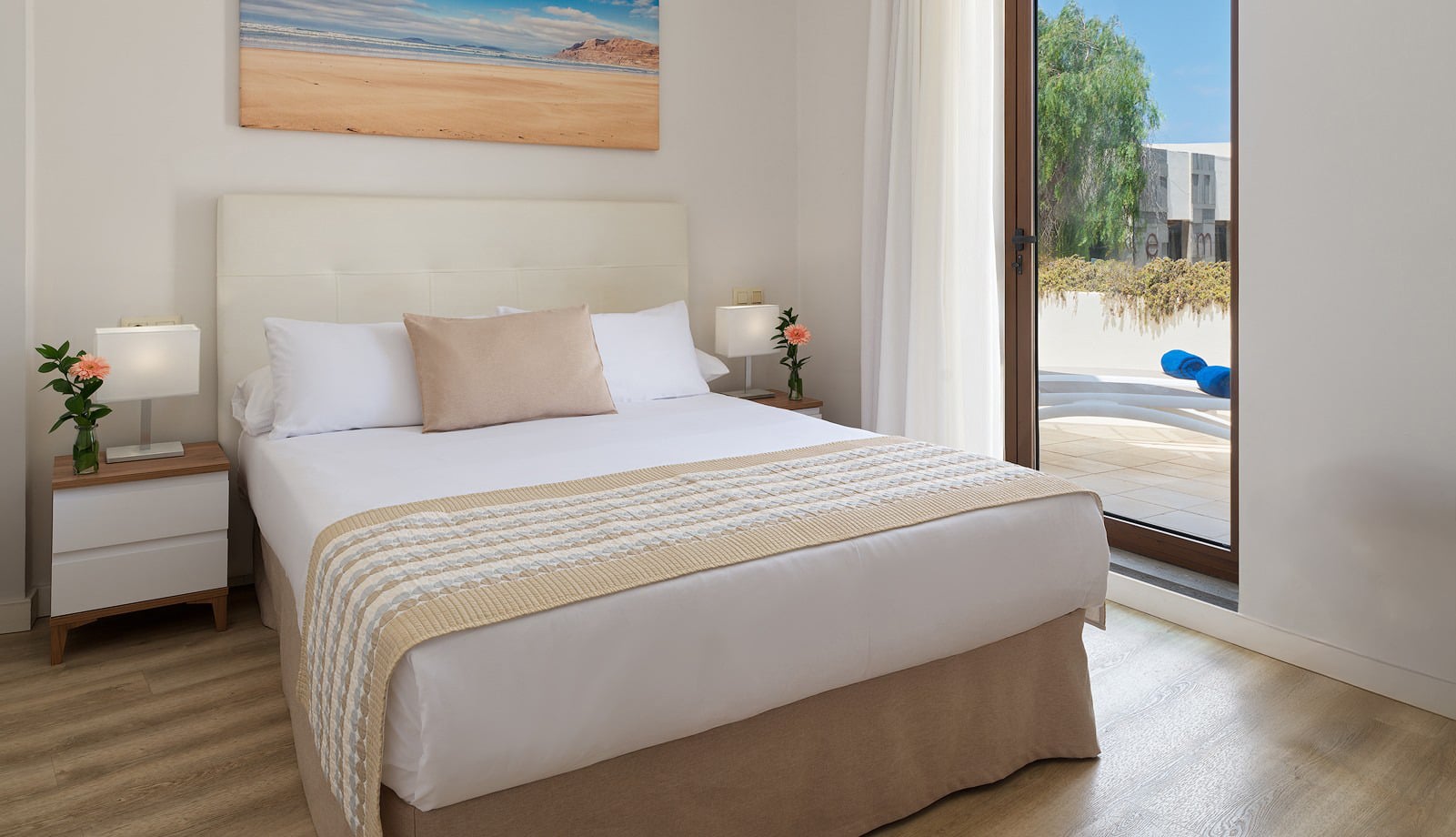 Habitación doble con Habitaciones y Suites | Los Zocos Impressive Lanzarote, batas blancas, y vistas a la costa.