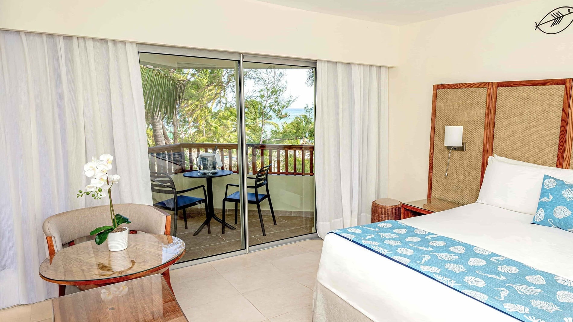 a hotel room with a large bed and a blue couch