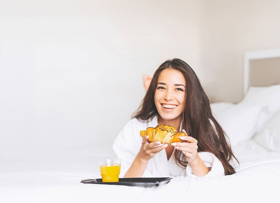 a large body of water with a cliff in the background