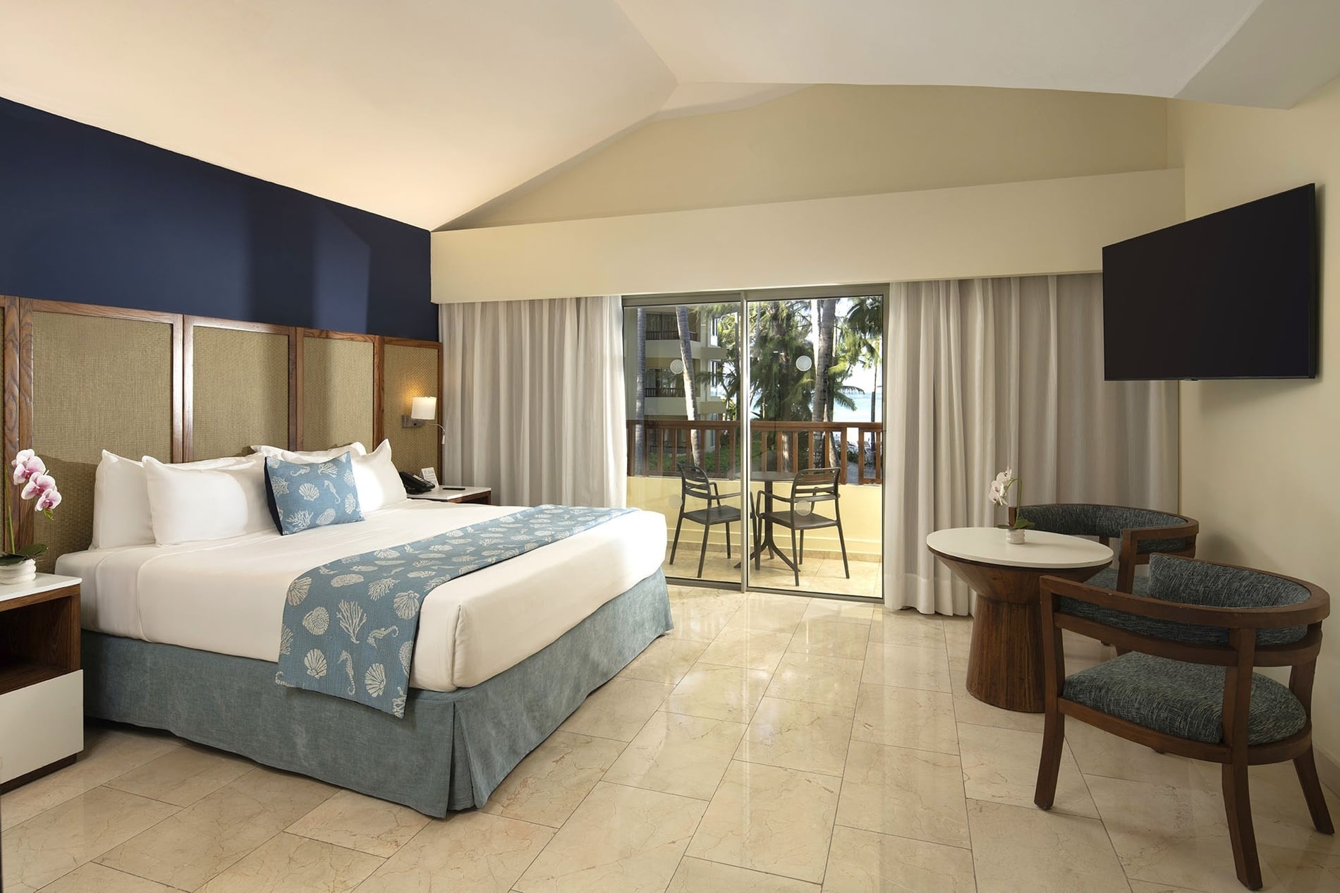 a hotel room with a large bed and a blue couch