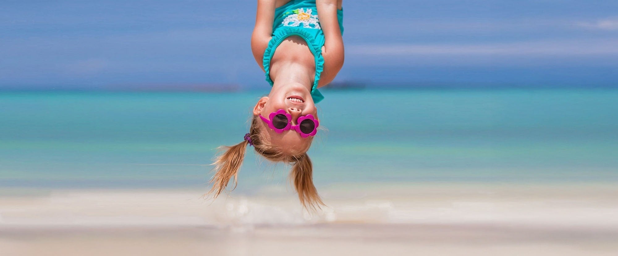 an aerial view of a sandy beach with blue water