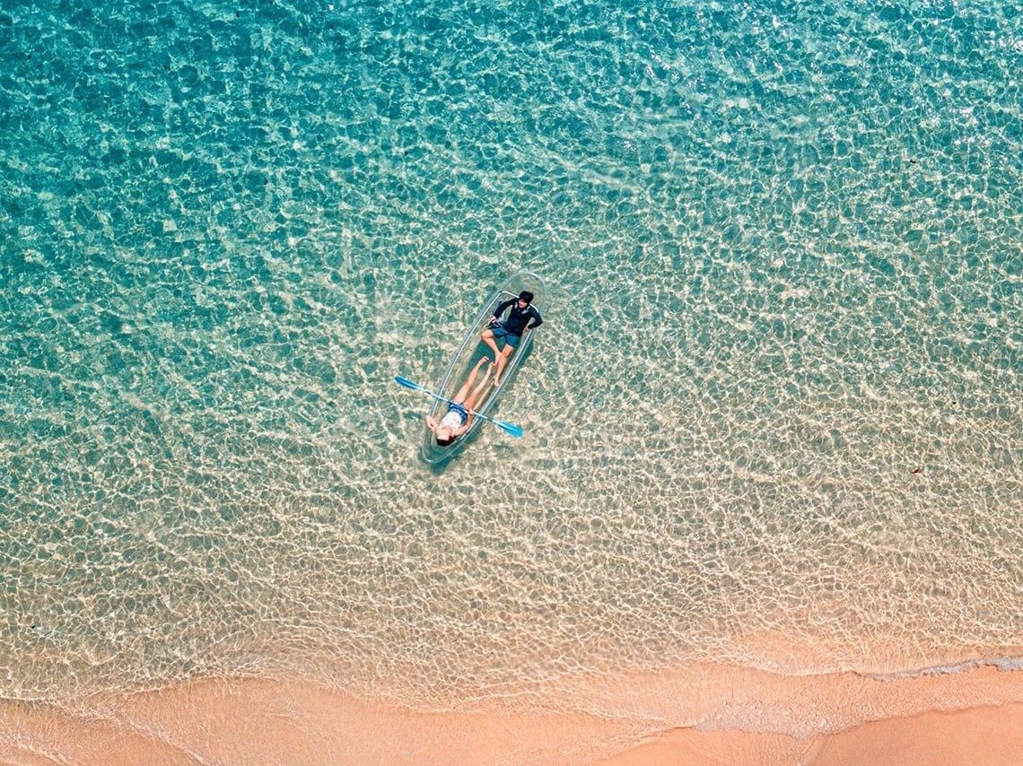 a large body of water with a cliff in the background