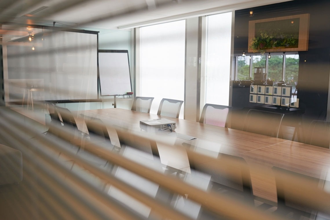 
                                    a conference room with a long table and chairs and a projector