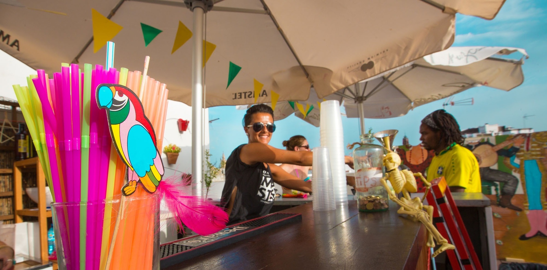 a woman behind a bar with a parrot on it