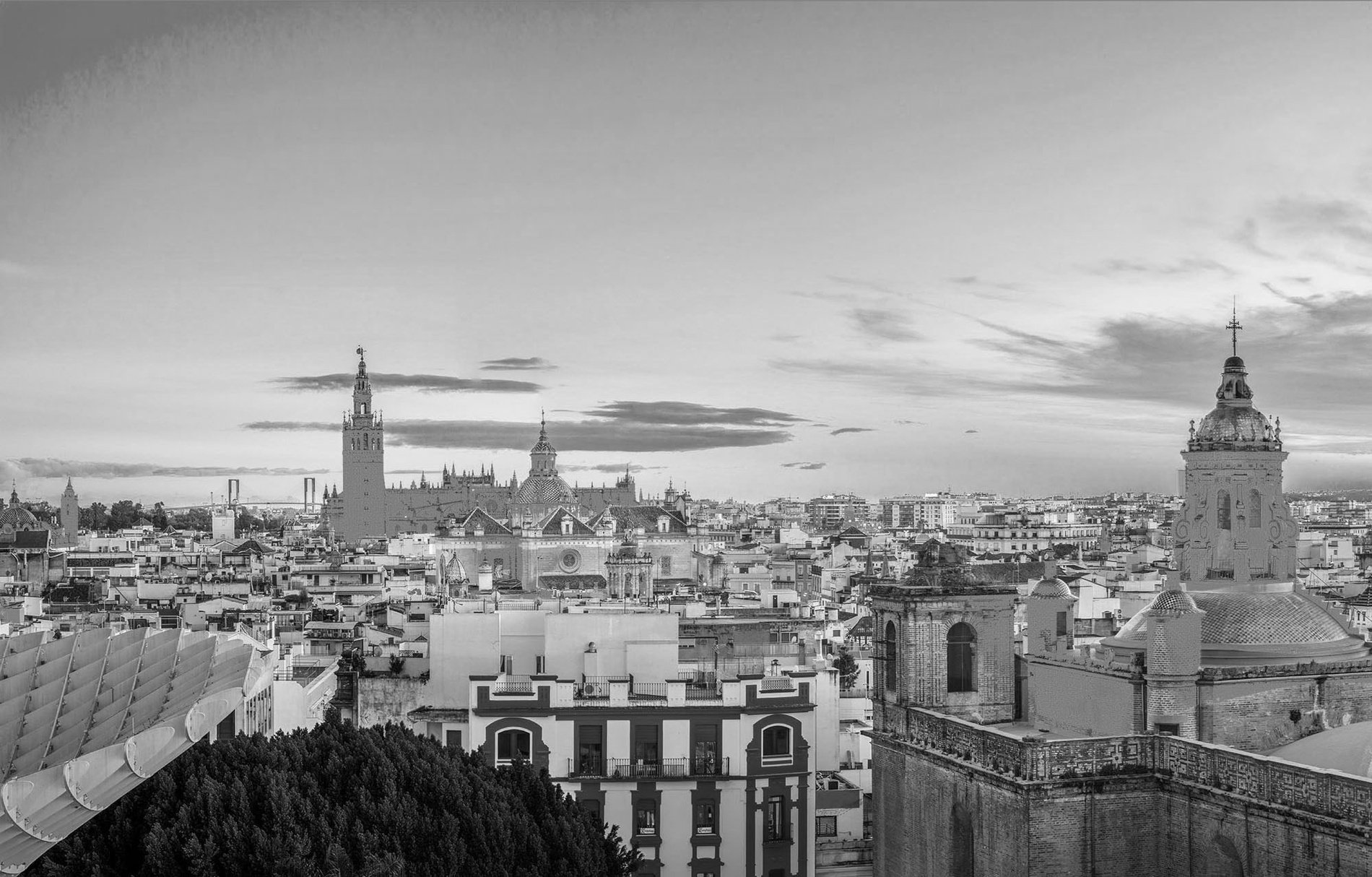 a black and white photo of a city with a clock tower in the foreground=s1900