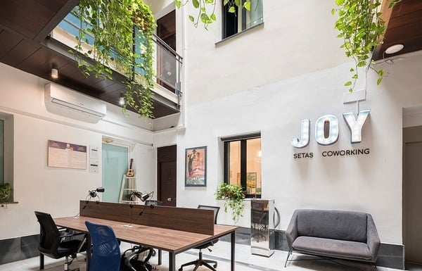 una vista aérea de una persona sentada en un escritorio con una computadora portátil