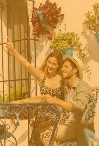 a man and a woman are sitting at a table looking at a map