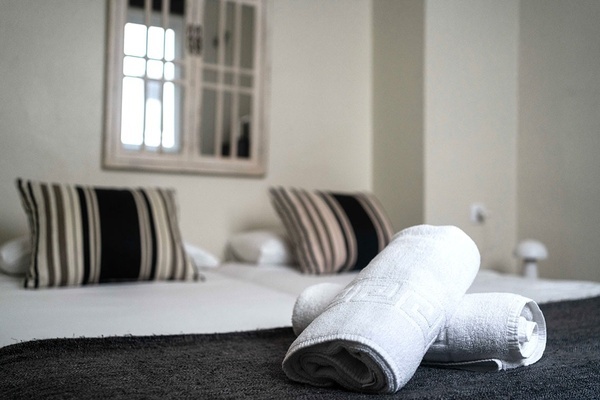 two towels are rolled up on a bed in a hotel room