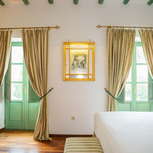 Elegant room with green doors and striped curtains, Juderia: Cordoba.