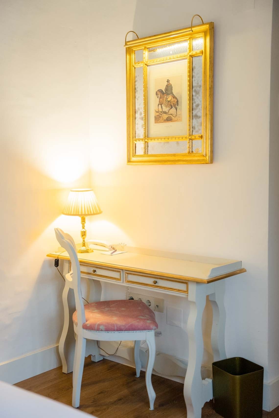 Desk and chair in Juderia: Cordoba hotel room with ornate mirror and lamp.