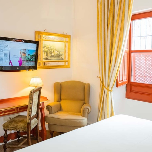 Elegant room with desk and armchair in Juderia: Cordoba.