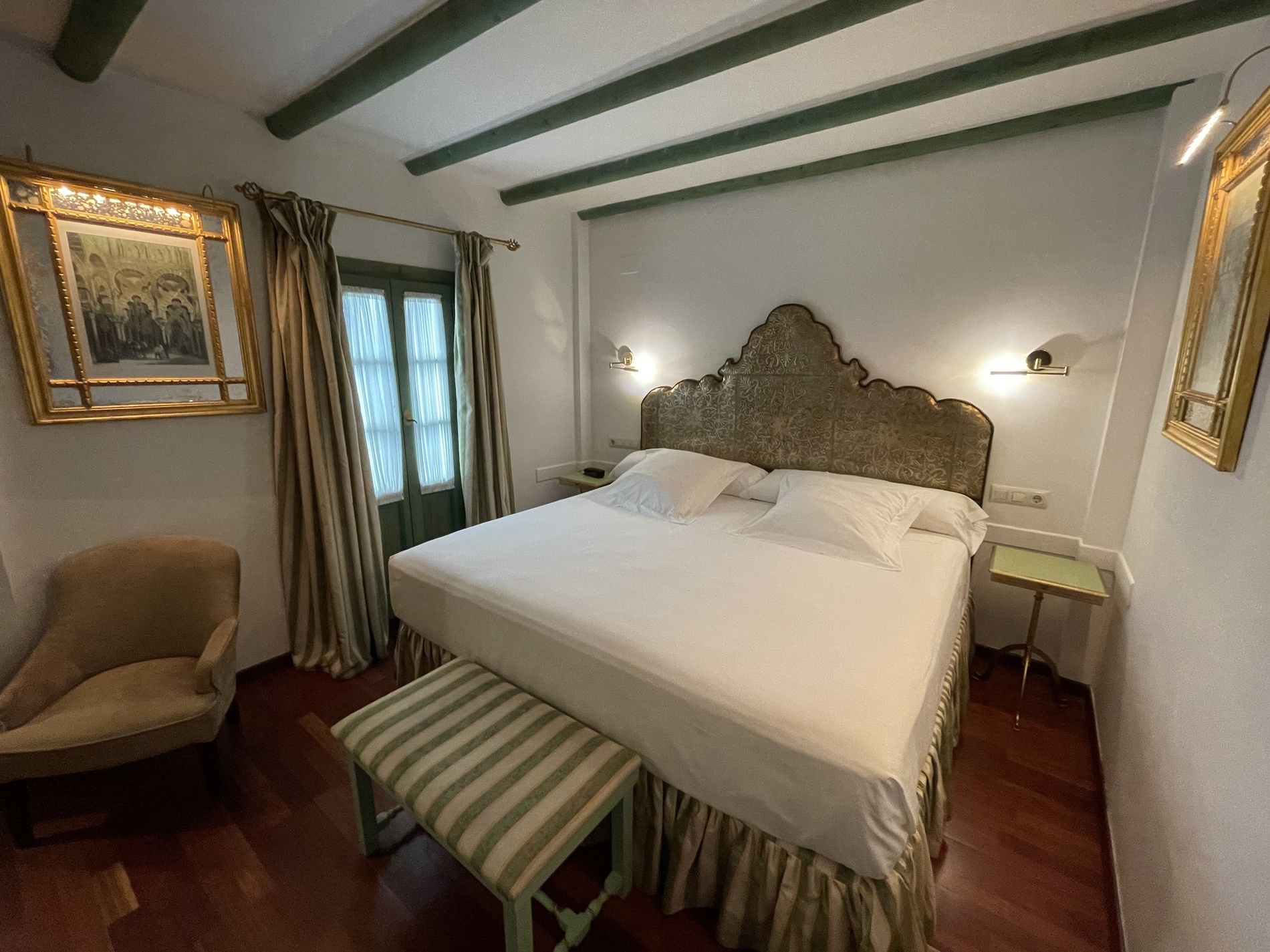 a bedroom with a large bed and a chair