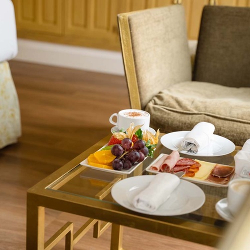 Hotel breakfast service with fruit, pastries, and coffee, located near Juderia: Cordoba.