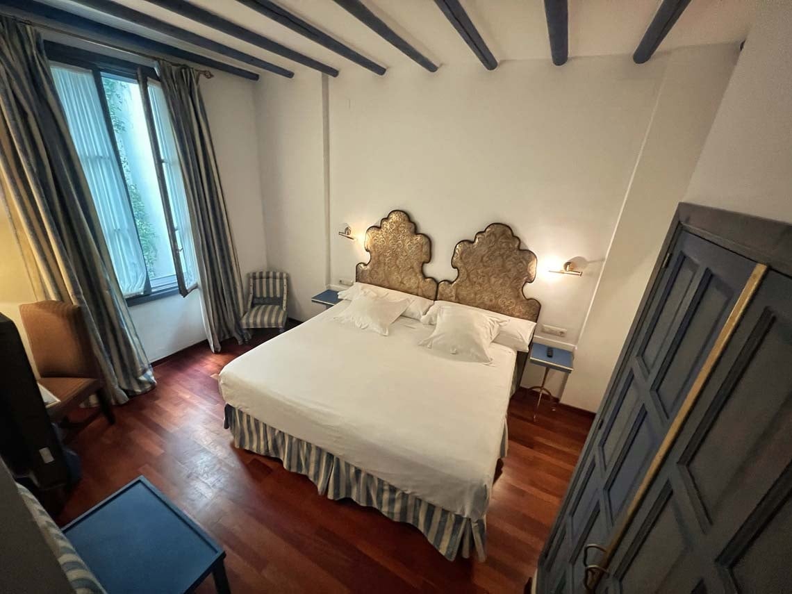 Elegant hotel room with a large bed and traditional decor in the Judería, Cordoba.