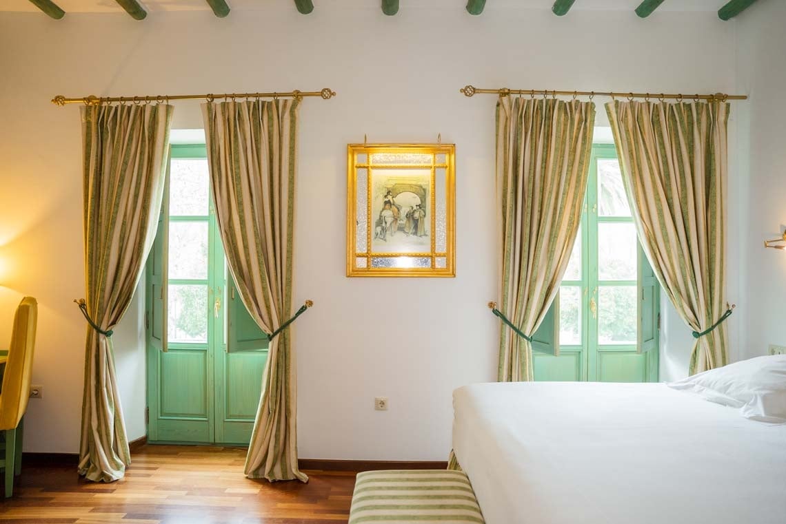 Elegant room with striped curtains and a framed artwork in Juderia: Cordoba.