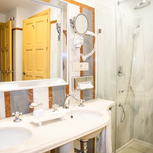 Luxurious Juderia: Cordoba hotel bathroom with double sinks and marble shower.