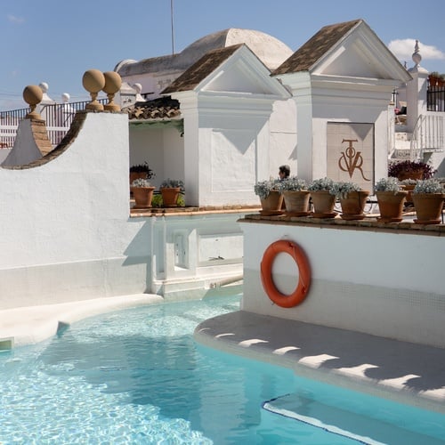 Rooftop pool with a life preserver and pots of flowers in Juderia: Sevilla.