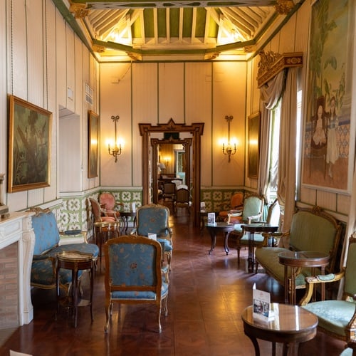 Elegant lounge in Juderia: Sevilla hotel with ornate furniture & decor.