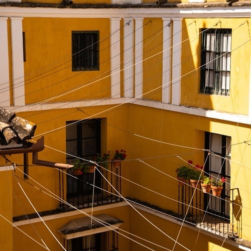 Charming yellow building with balconies in Juderia: Sevilla.