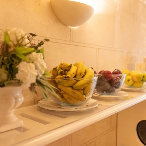 Fresh fruit bowls and flowers on display at Juderia: Sevilla, a healthy breakfast option.