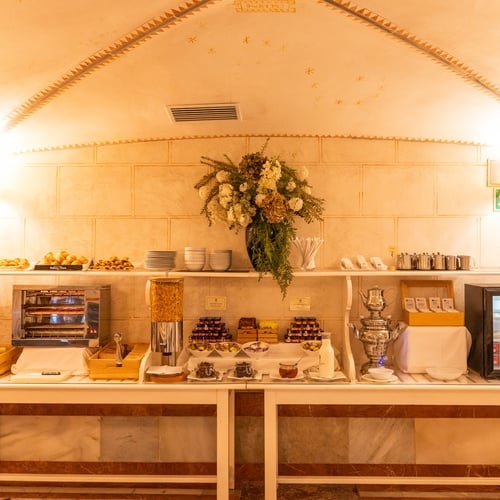 Breakfast buffet at Juderia Sevilla: croissants, cereal, jams, and mini-fridge.