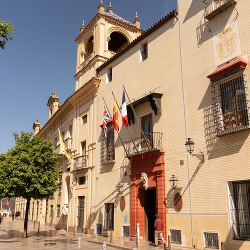 Seville Juderia hotel: Spanish & UK flags outside historic building.