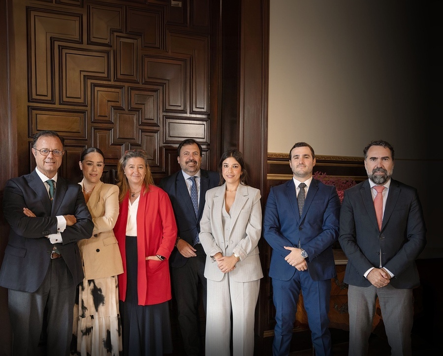 a group of people posing for a picture with their arms crossed