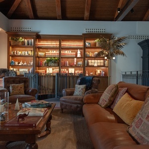 a living room with a couch and chairs and a coffee table with a book titled africa on it