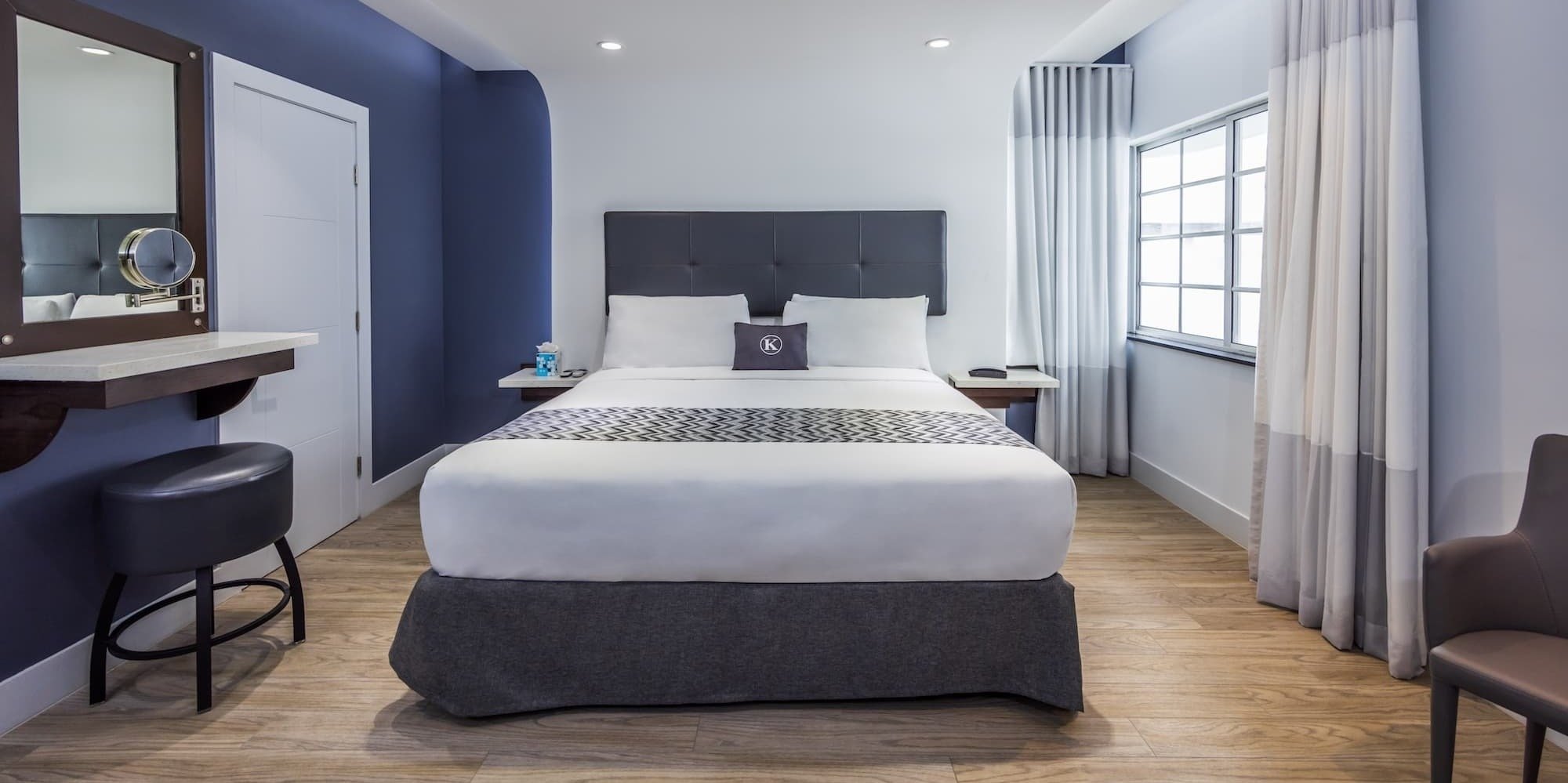 a hotel room with a large flat screen tv above the bed