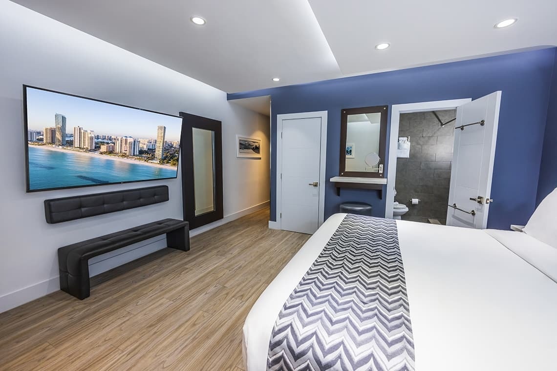 una habitación de hotel con una cama y una televisión en la pared