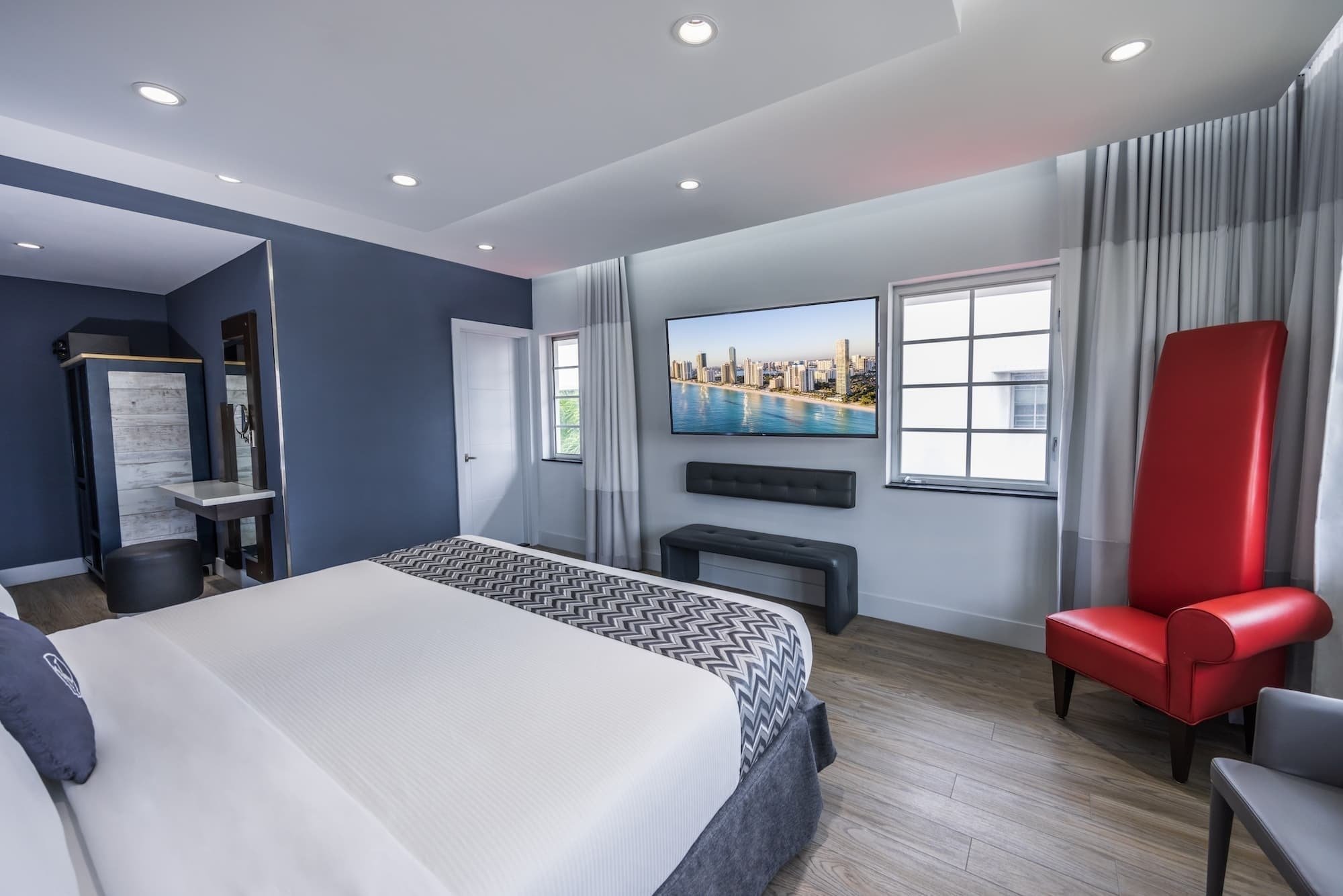 a hotel room with a large flat screen tv above the bed