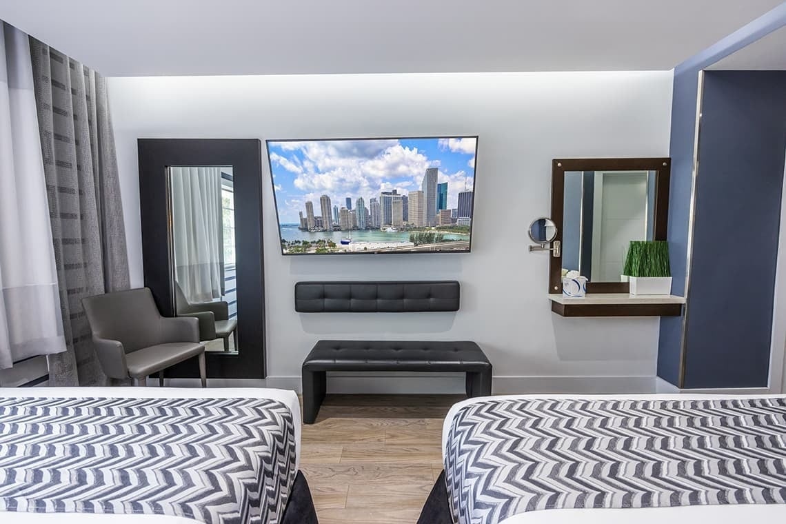 una habitación de hotel con dos camas y una televisión