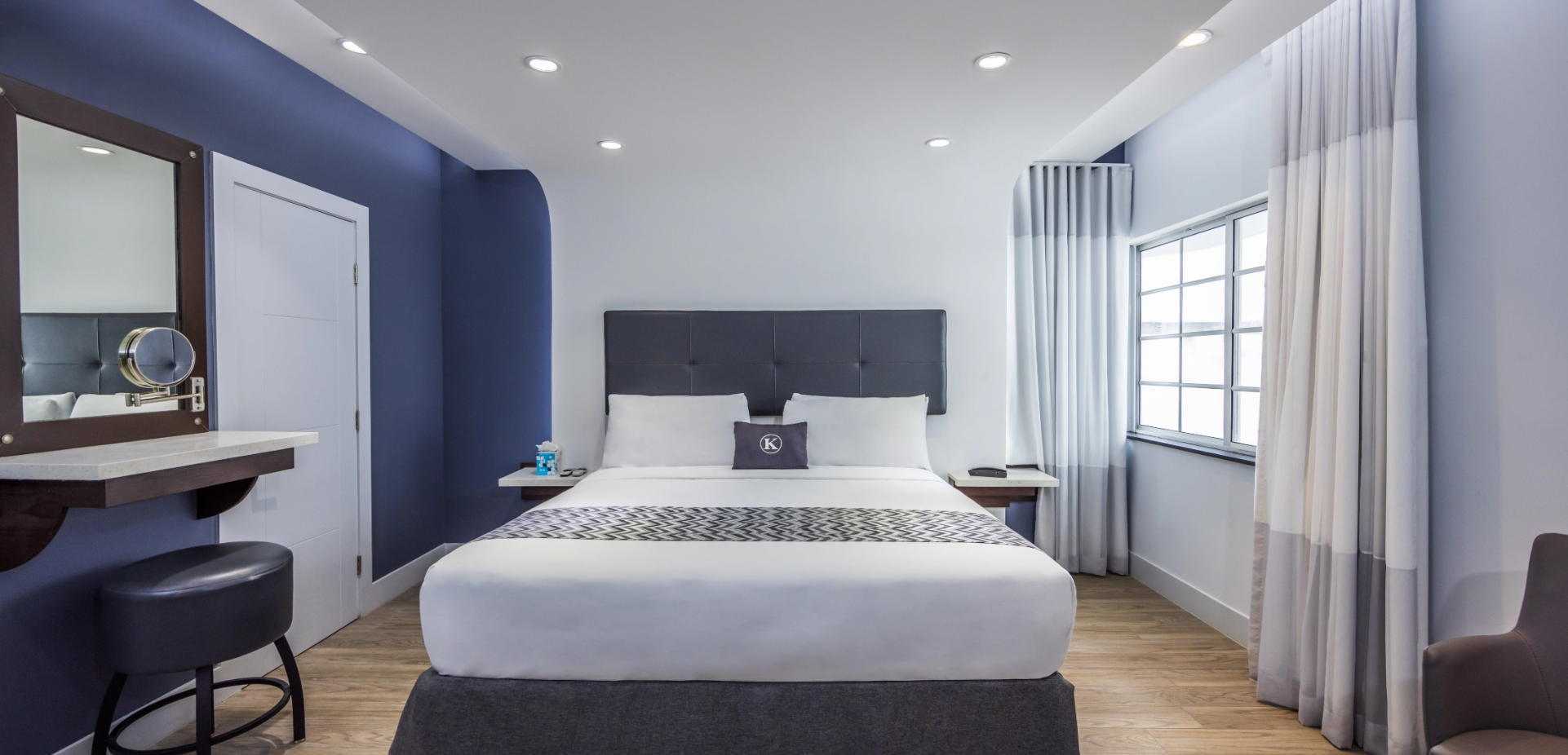 a hotel room with a bed and a mirror