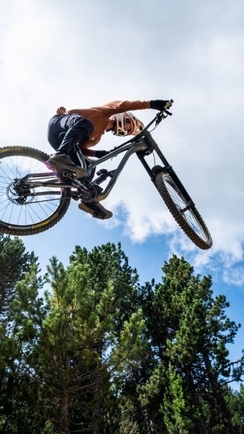 Espectacular salto de MTB en Bike Park Andorra. Vive la emoción con nuestro Hostel + Forfait Pal Arinsal 2026.