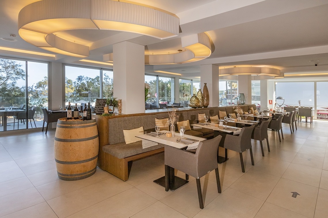 una bebida roja con una pajita en la playa